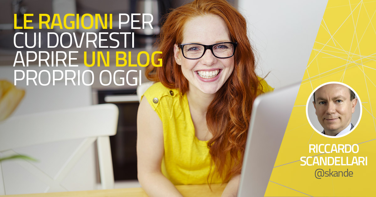 red headed smiling girl writing on a laptop